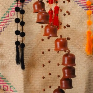 Campana decorativa colgante de barro hecha a mano, ideal para ambientar espacios con un toque artesanal y sonido relajante.